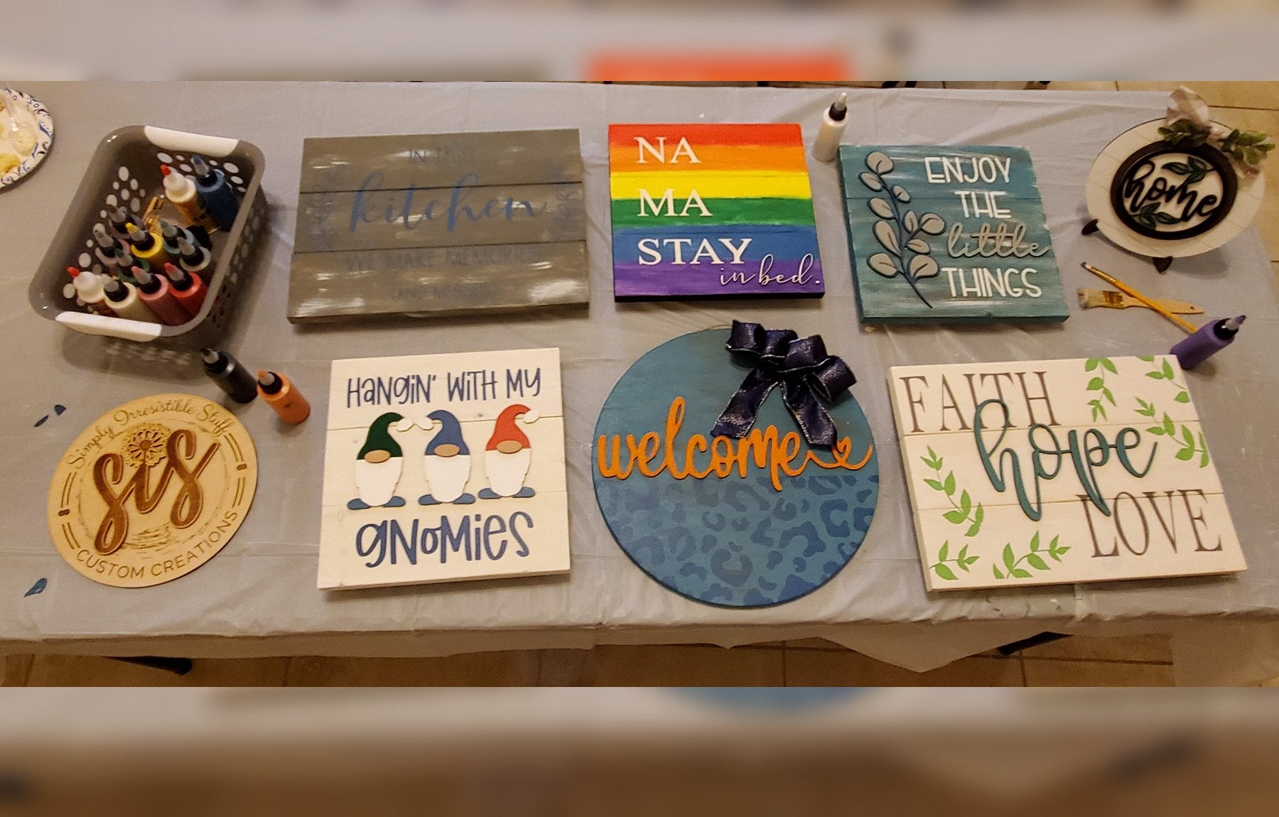 Overhead view of completed paint party projects and supplies